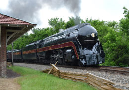 The Class J #611 passes the old passenger depot at The Plains