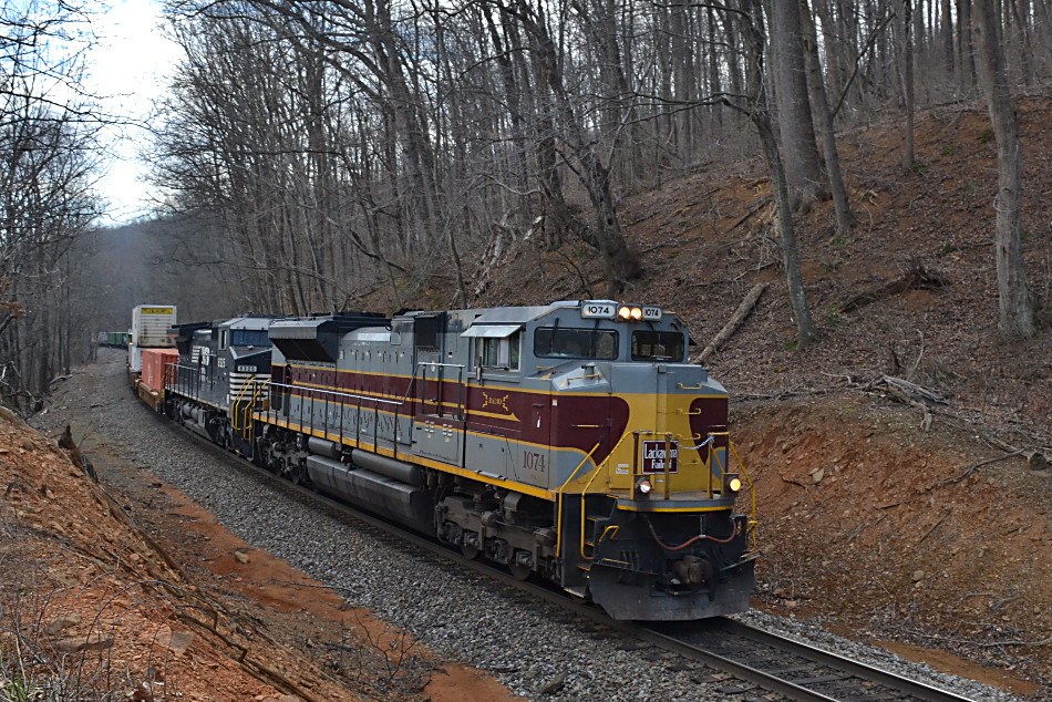 SD70ACe #1074, the Delaware Lackawanna & Western heritage unit , leads NS train 290 west up Linden Hill on 2/20/2017