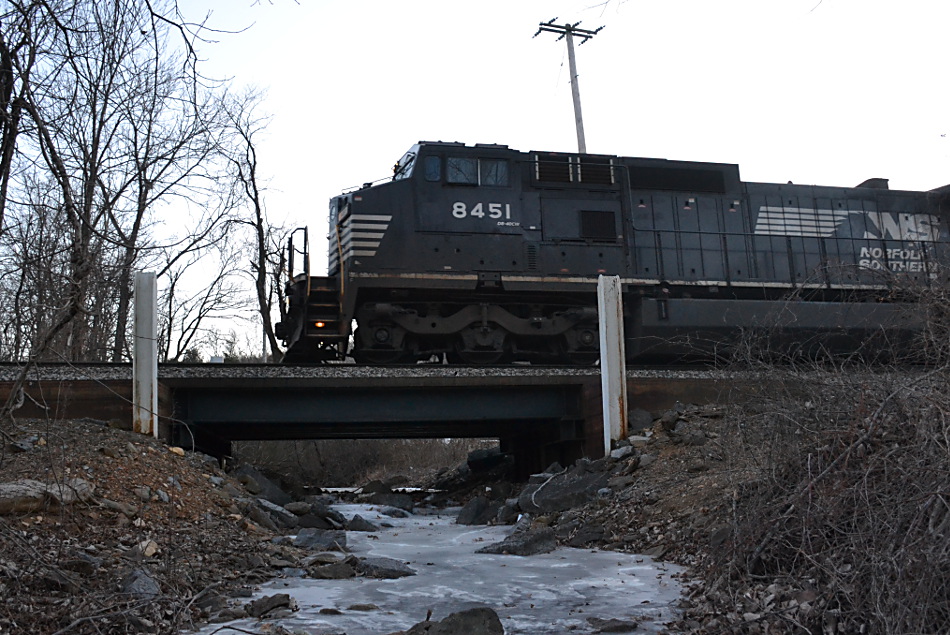 NS train 203 is led by NS (Ex-Conrail) D8-40CW #8451 east over a frozen stream in Linden, Va on 1/6/2018.