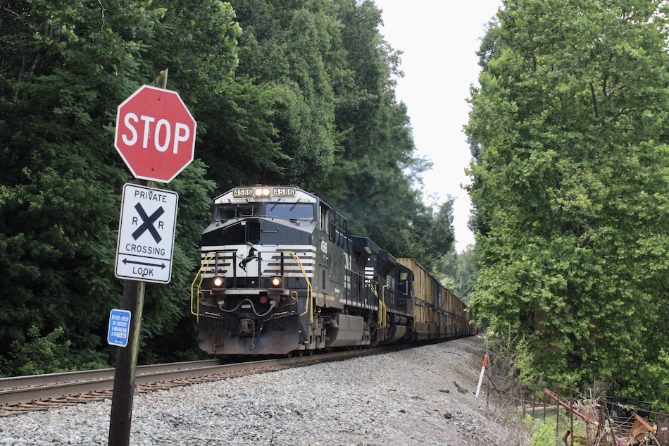 A Norfolk Southern train passes by a private crossing.