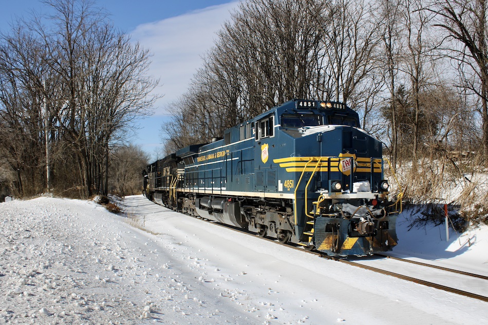A specially painted Norfolk Southern heritage unit leads a train through Virginia after a snowstorm.